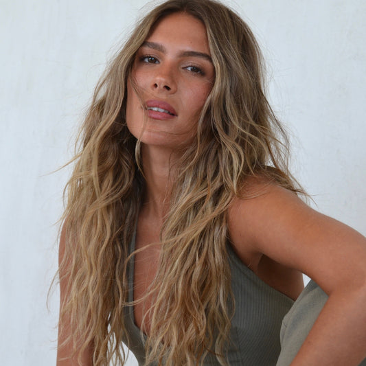 LINEONE Hair Sun-kissed bronde model in olive ribbed tank with long beachy Keratin Tip Wavy textured hair