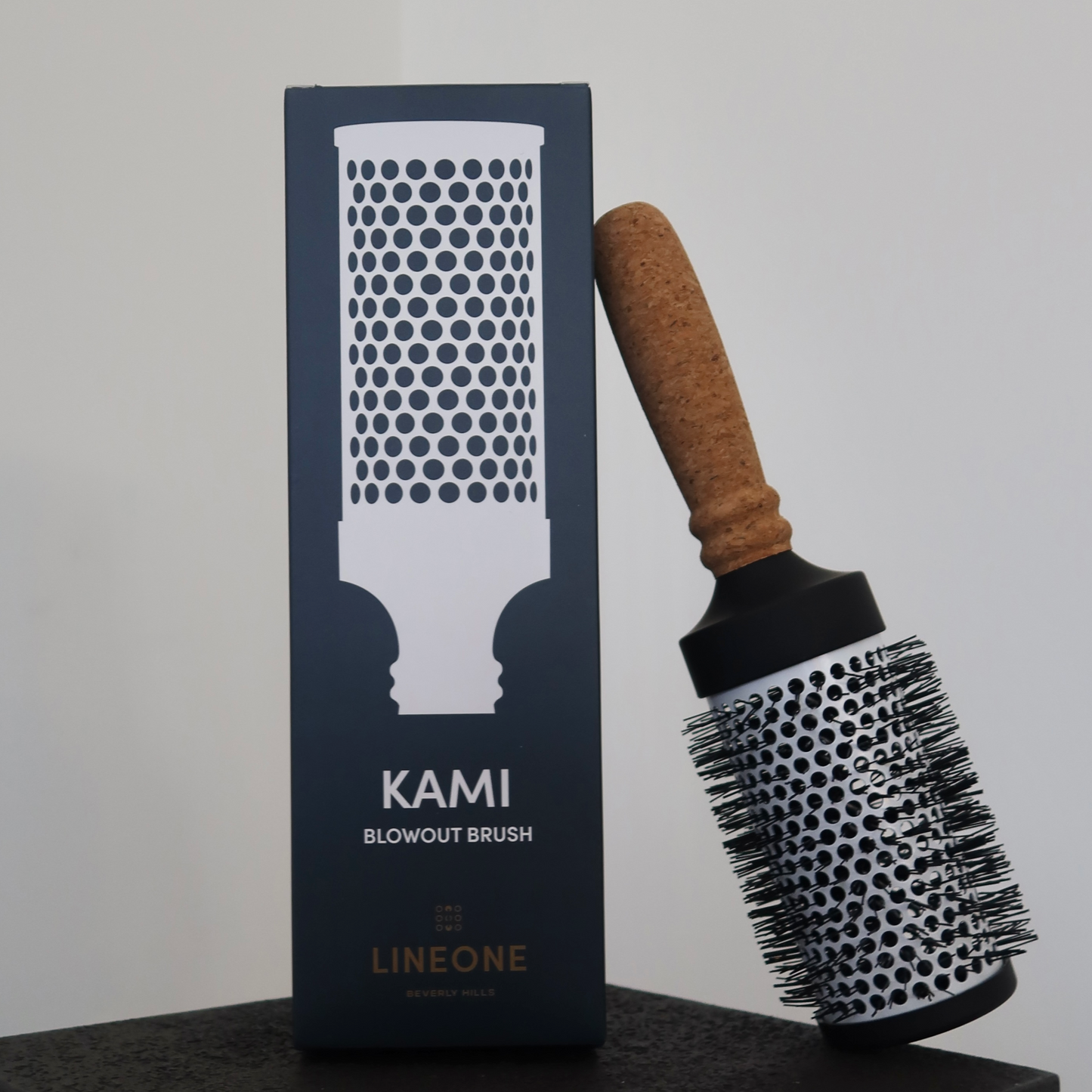 LINEONE Hair KAMI Blowout Brush propped beside its tall navy patterned packaging box