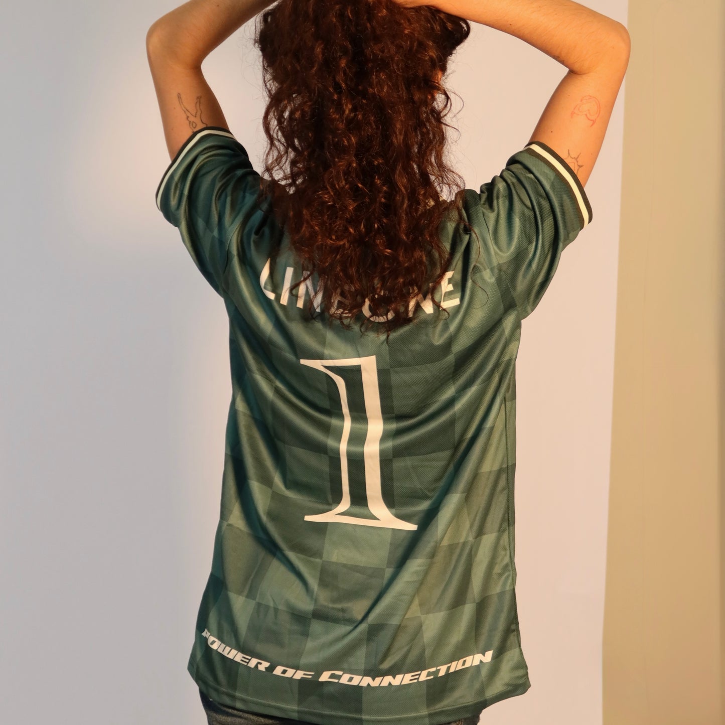 Back of LINEONE Hair Team Works Jersey in green showing LINEONE wordmark, number 1 and Power Of Connection hem