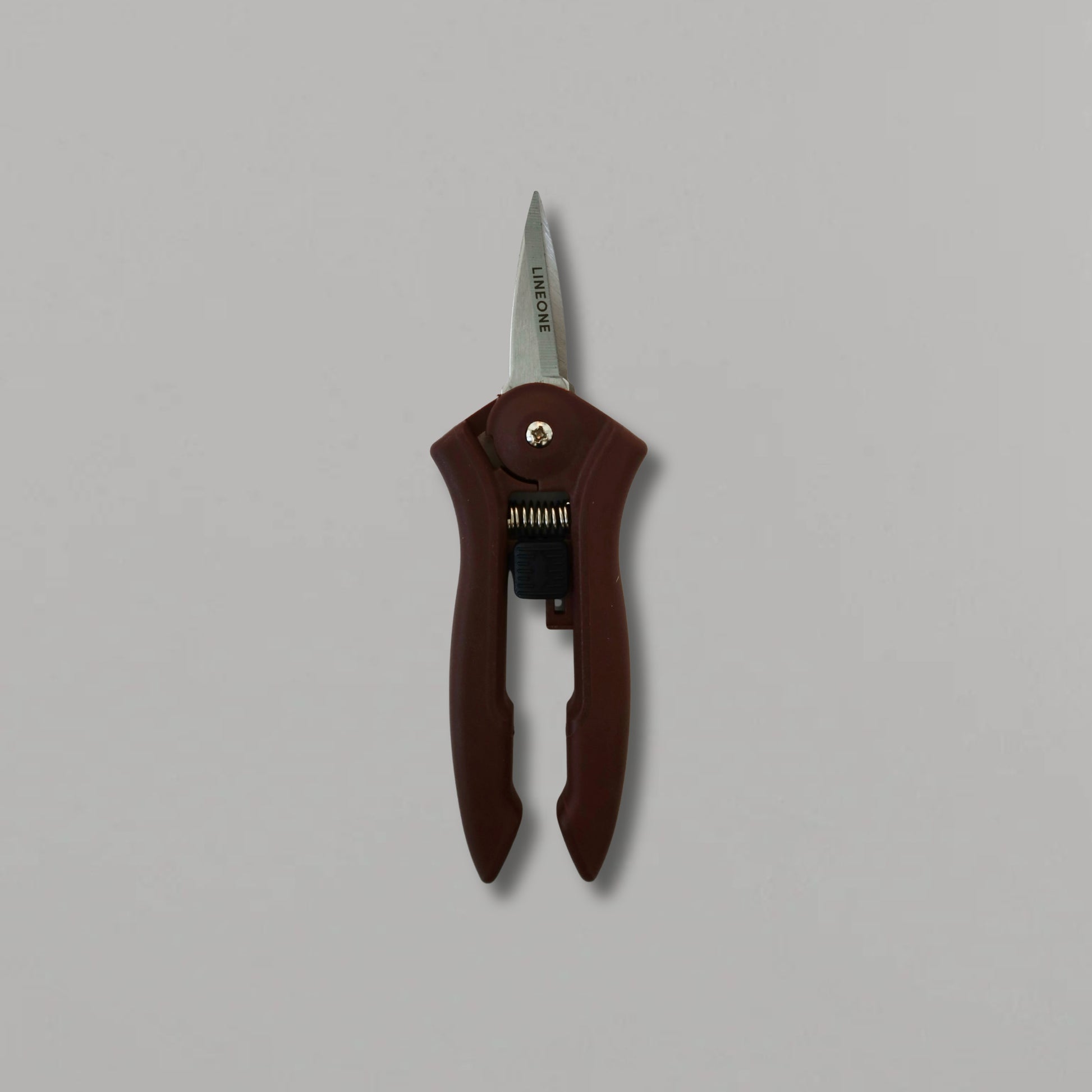 LINEONE Bond mini trimmer hero shot standing upright showing full tool with dark brown handle and stainless steel blade on gray background