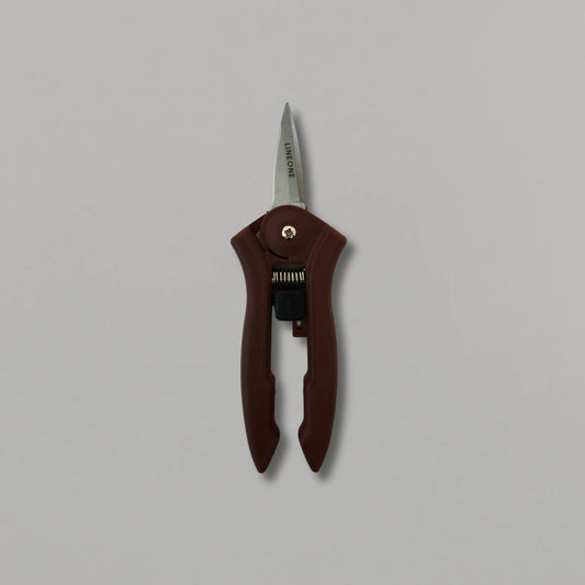 LINEONE Bond mini trimmer hero shot standing upright showing full tool with dark brown handle and stainless steel blade on gray background