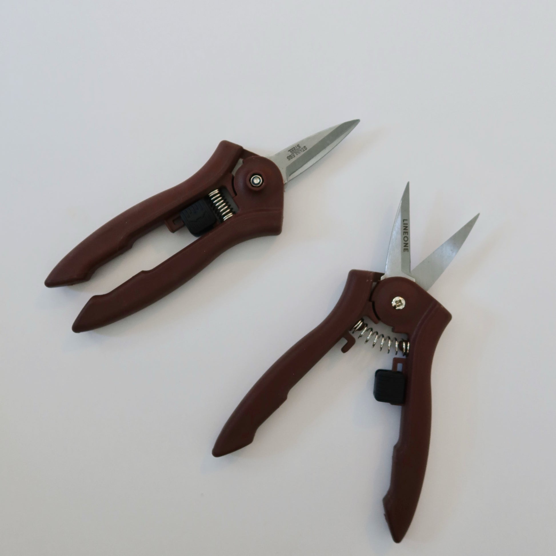 Two LINEONE Bond mini trimmers shown from different angles displaying the full tool with dark brown handles and stainless steel blades on white background