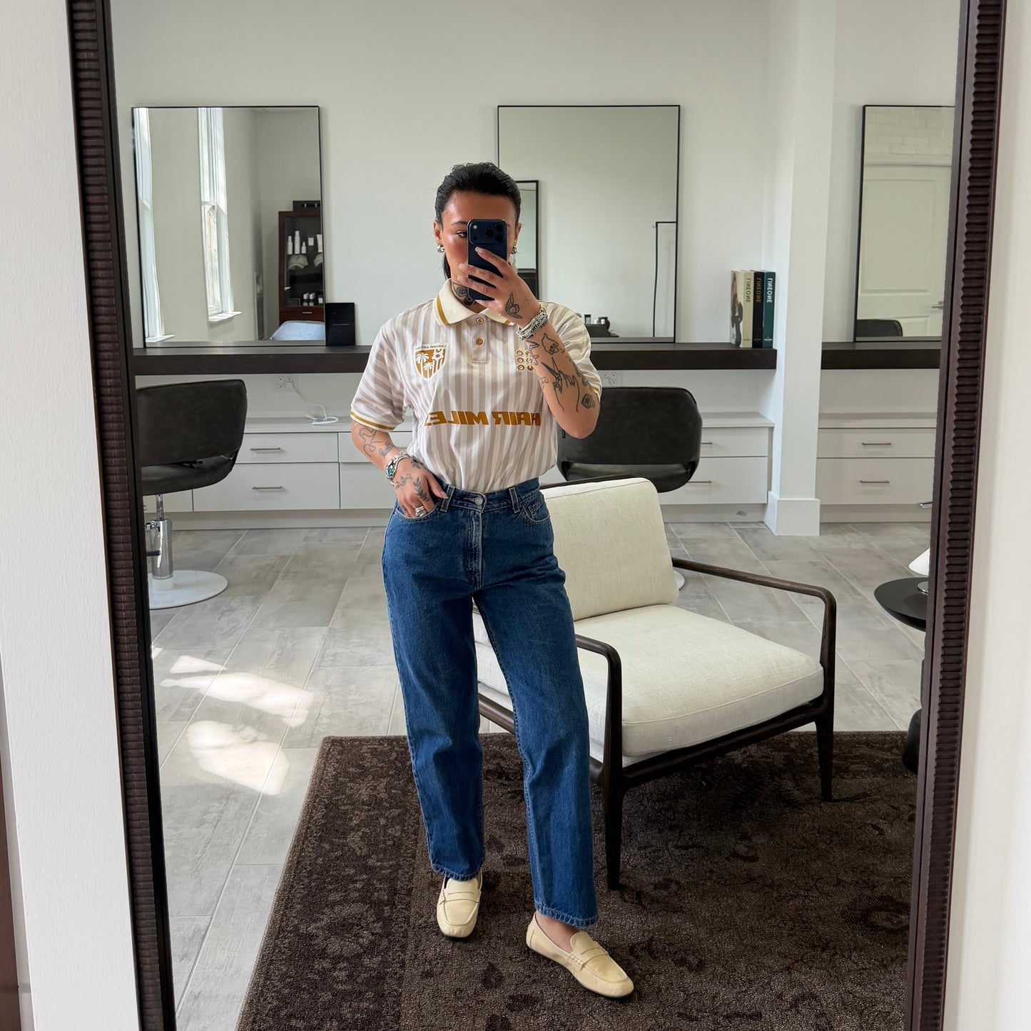 Salon mirror selfie of model in cream Hair Miles jersey, LINEONE Hair Jeans and loafers
