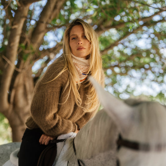 Blonde rider in camel cashmere on a grey horse under dappled trees, LINEONE Hair Hybrid Intro Kit Dimensional Blonde