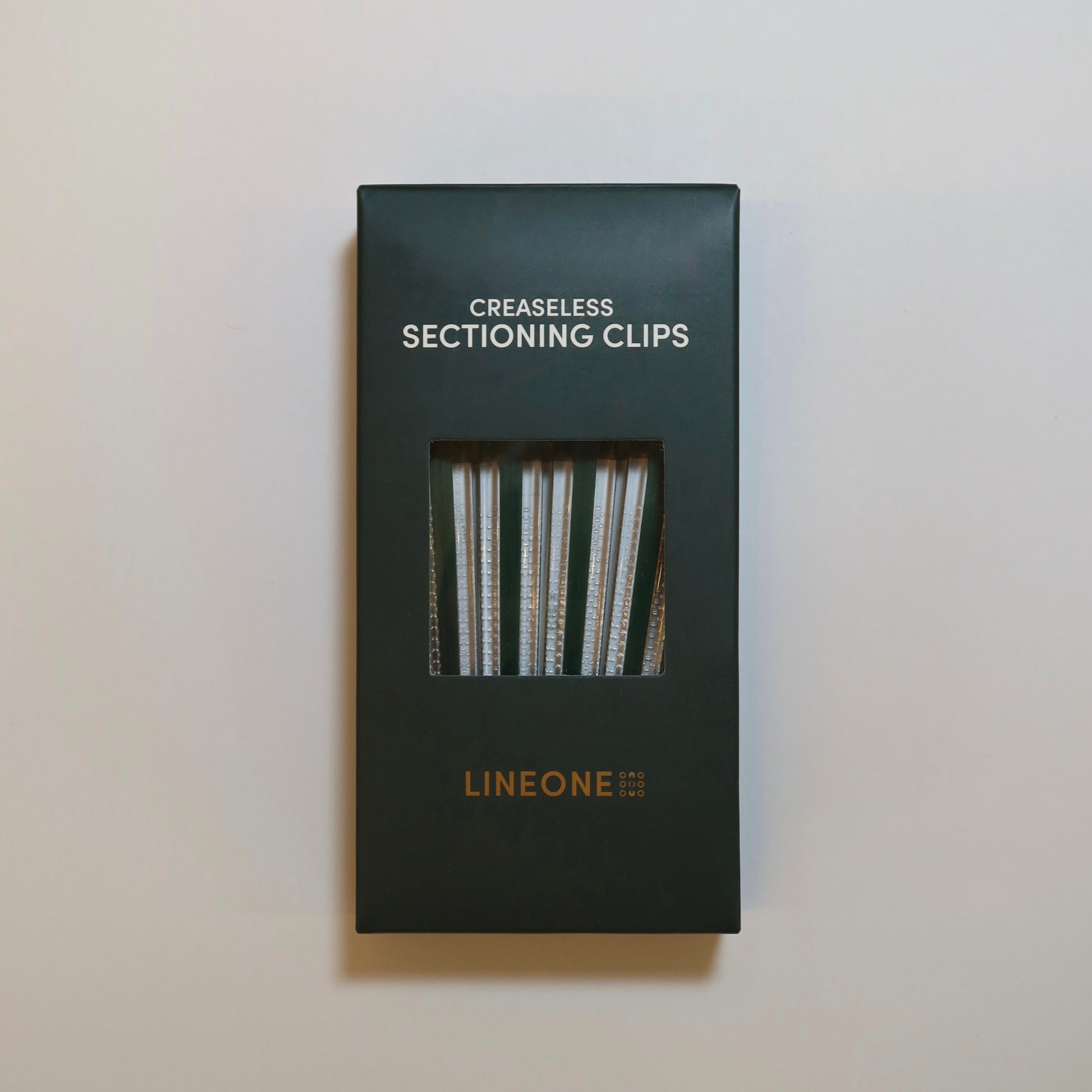 LINEONE Hair Creaseless Sectioning Clips hunter green box front view with clear clips through window