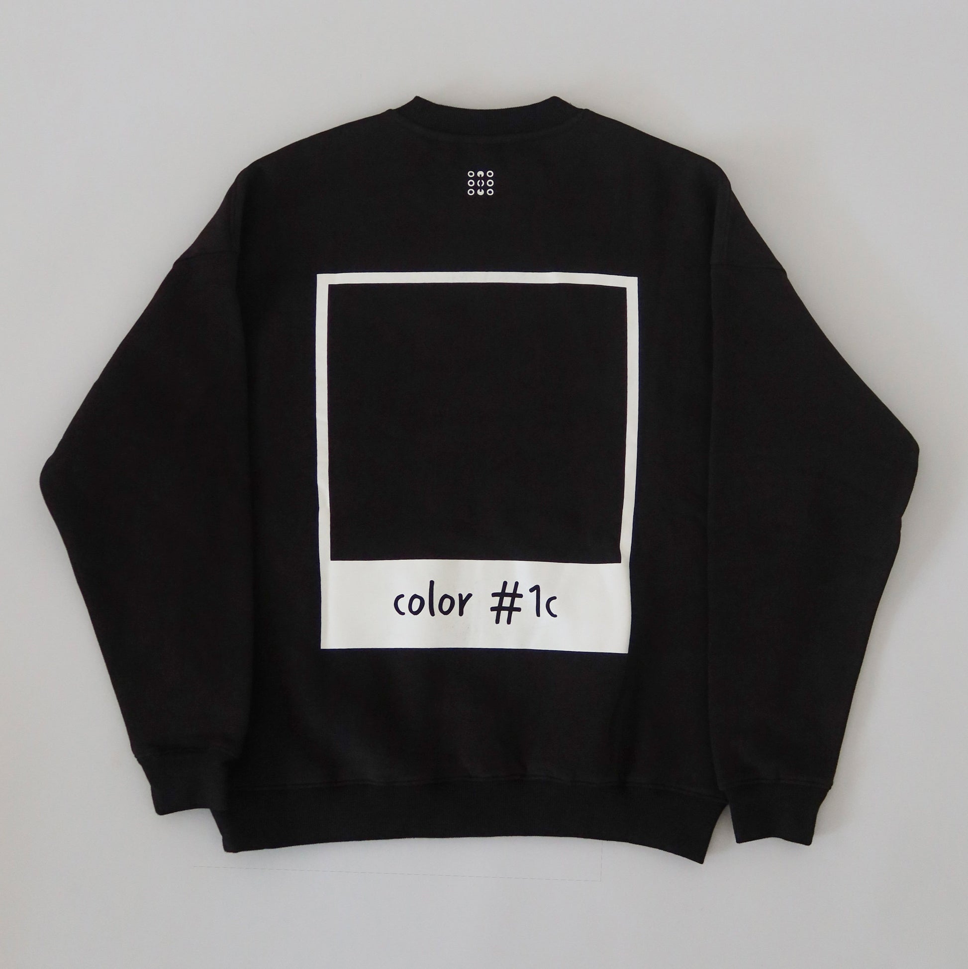 Black LINEONE Hair Pantone Crewneck laid flat showing full back polaroid color #1c print, shade #1C